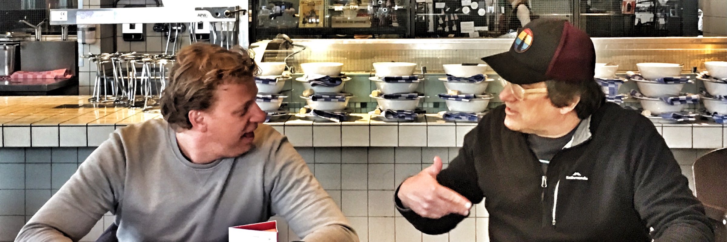 Jim having a discussion with a client in a restaurant